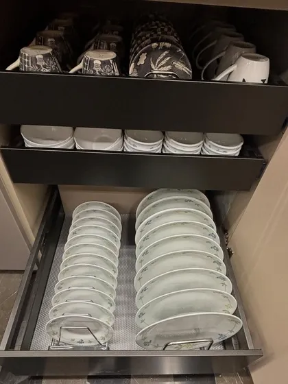 A pull-out drawer system for plates. Using racks to stack plates vertically prevents chipping and makes it easy to take one without lifting the whole stack.