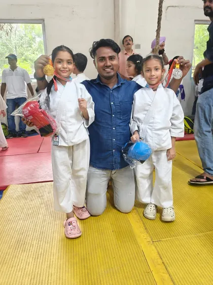 Two of our young girl champions showing off their medals after a tough competition. We train them to be strong, confident, and ready for any challenge.
