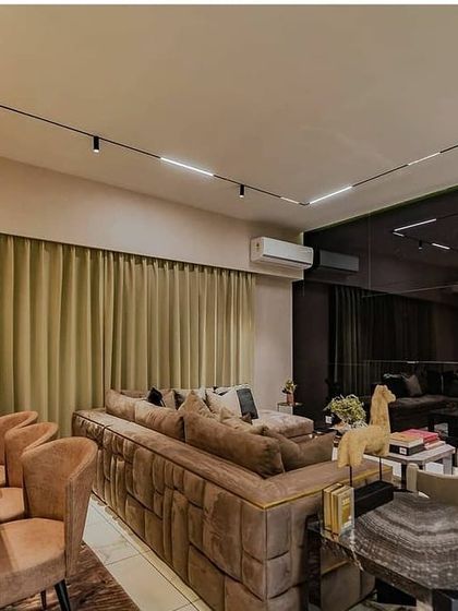 In this living and dining area, a magnetic track lighting system provides ultimate flexibility. It allows the homeowners to position spotlights and linear modules exactly where needed, whether for illuminating the dining table, highlighting artwork, or providing general ambient light.