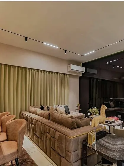 In this living and dining area, a magnetic track lighting system provides ultimate flexibility. It allows the homeowners to position spotlights and linear modules exactly where needed, whether for illuminating the dining table, highlighting artwork, or providing general ambient light.