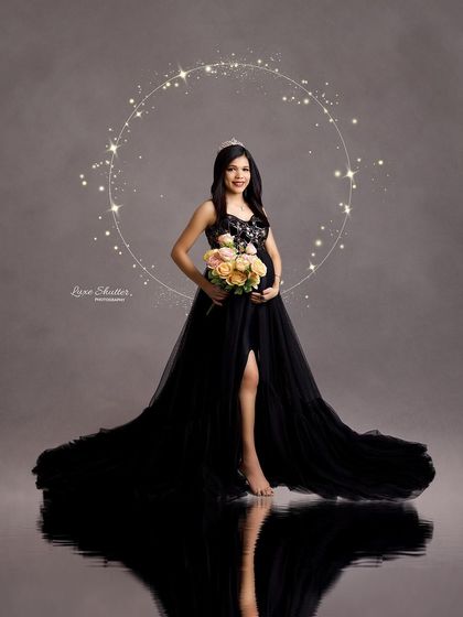 Adding a sparkling ring of light and a bouquet of flowers transforms this portrait into a magical, celebratory moment. The black gown provides a perfect, elegant base.
