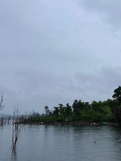 A panoramic view of the Vani Vilas Sagar backwaters on an overcast day, highlighting the vast and tranquil landscape.