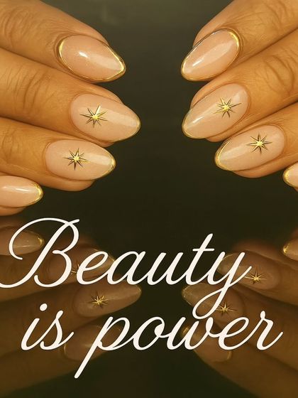 An elegant nude manicure with gold chrome outlines and delicate gold starburst accents.