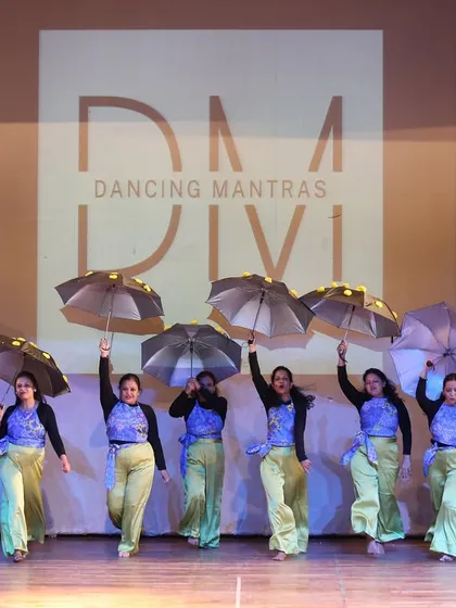 A glimpse from our 'City of Stars' showcase, where my students owned the stage. I love incorporating props like these umbrellas to add a unique visual flair to a group dance, creating a truly memorable sangeet performance.