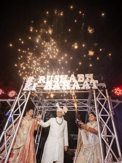 The Baraat culminates in a grand welcome. For this groom, I designed a custom truss with his name, lit up with fireworks as he made his celebratory entrance, marking the start of the festivities.