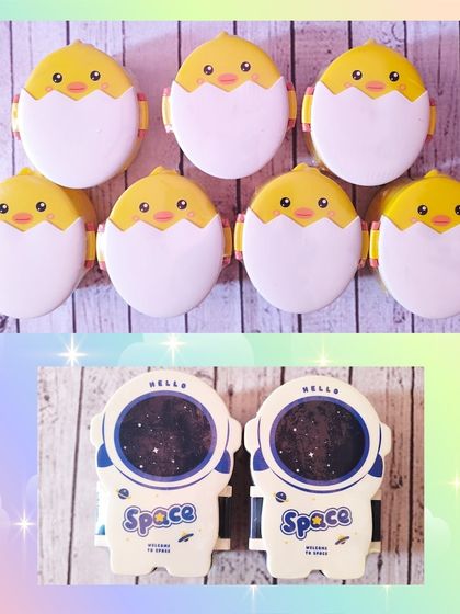 These snack boxes, shaped like a hatching chick or an astronaut's helmet, are a fun and unique item.