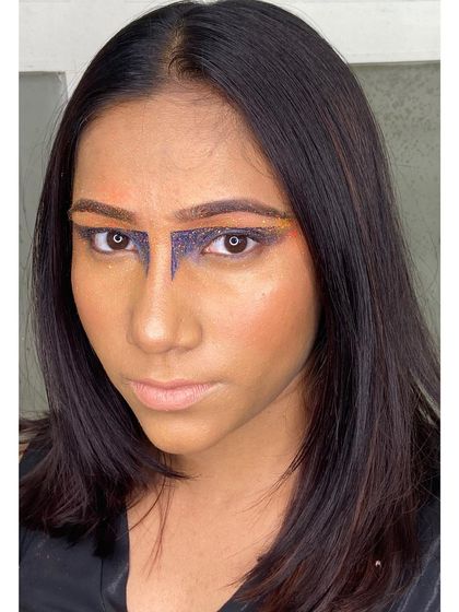 An experimental editorial look featuring a strong, graphic T-zone shape created with glitter. This style is perfect for high-fashion concepts that require unconventional beauty looks.