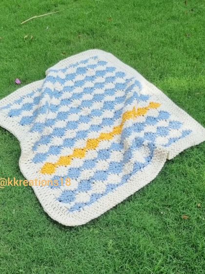 This gingham-style crochet baby blanket is one of my favorite designs. I made this one in blue, white, and a pop of yellow. It's so soft and has a wonderful, comforting weight to it.