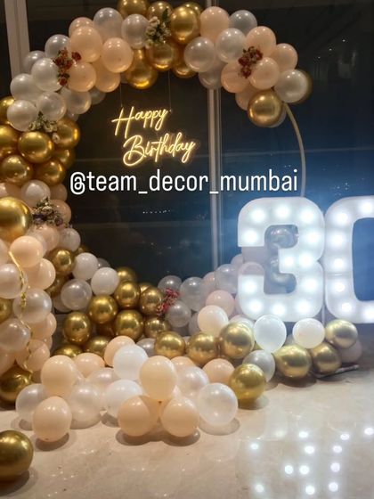 The full view of the 30th birthday setup, showcasing the beautiful combination of balloons, neon, and marquee lights.