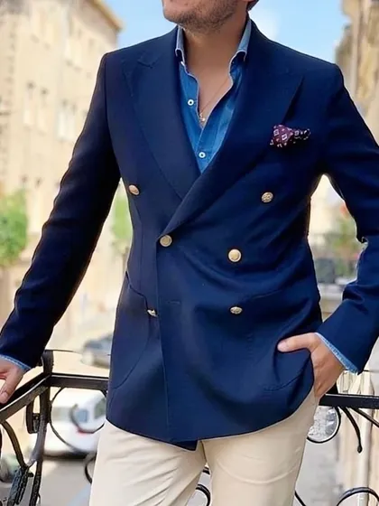 A navy double-breasted blazer is a versatile and powerful piece. Paired here with light trousers, it demonstrates a sophisticated business-casual look, perfect for making an impression.