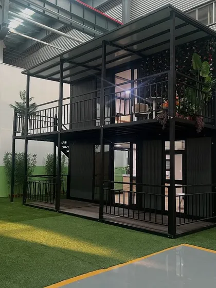 Another angle of the two-story container home, showcasing the external staircase and dual balconies. This design provides multiple outdoor areas for relaxation and entertainment.