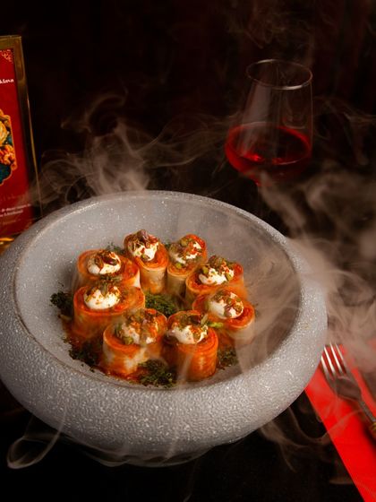 This is our Turkish Beyti Kebab, presented with dramatic smoke. Each bite is a journey into the rich, savory world of authentic Turkish cuisine.