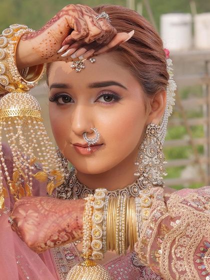 This bride's look is a perfect example of modern elegance. The pink monochromatic makeup is paired with stunning silver jewelry, creating a contemporary yet timeless bridal style.
