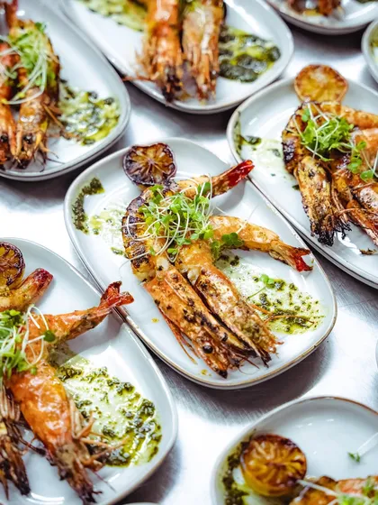 A full spread of our wood-fired tiger prawns, showing the consistent quality and beautiful presentation for a large group.