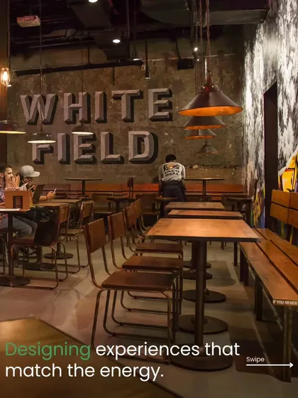 For the Taco Bell in Whitefield, we created an industrial-chic vibe that matches the energy of the area. The design features exposed concrete-style walls, custom typography, and warm wood furniture to create a space that feels both edgy and comfortable.