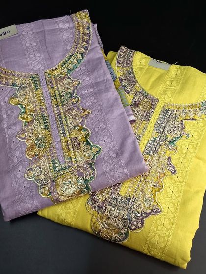 A selection of bright Mangalgiri cotton dress materials. Available in pastel purple and vibrant yellow, these sets feature heavy embroidery on the neckline and are perfect for festive wear.