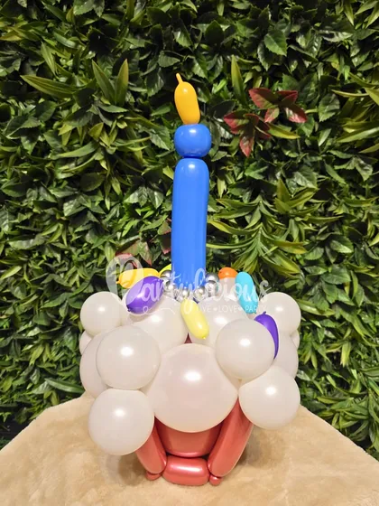 A close-up of a cupcake balloon sculpture, part of our chef-themed bouquet. The details, like the candle and sprinkles, are what make it special.