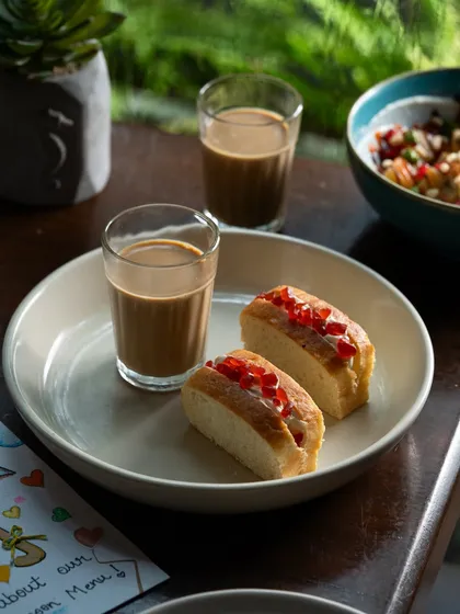 The quintessential Mumbai snack: bun maska and cutting chai. This shot evokes a strong sense of place and nostalgia.