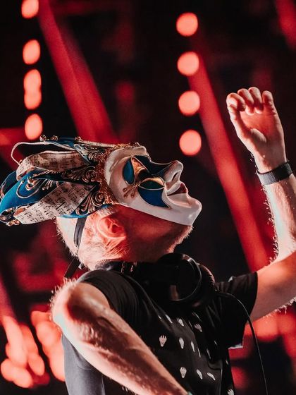 A side view of Boris Brejcha, capturing his focus and intensity as he performs.