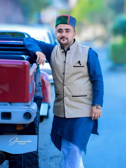 A proud 'Pahari' portrait. The subject's traditional kurta and Himachali cap, combined with a modern vehicle, create a great fusion look.