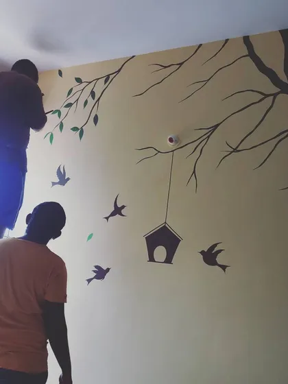 Our team at work on a nature-themed wall mural. We handle every step of the process, from initial design to the final brushstroke, ensuring a professional and high-quality result.