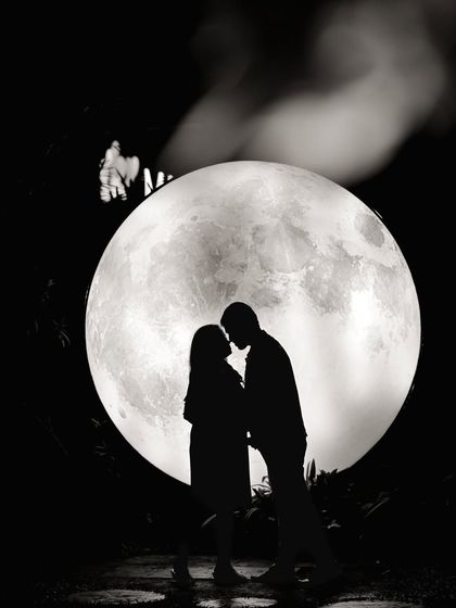A classic silhouette against our giant moon prop. This setup is perfect for creating timeless and artistic black and white couple portraits.