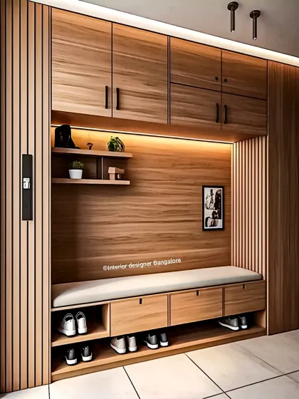 For homes that need maximum organization, we design full-height entryway units like this one. It features a mix of open and closed storage, a long cushioned bench, and dedicated nooks for shoes, ensuring a clutter-free and welcoming entrance.