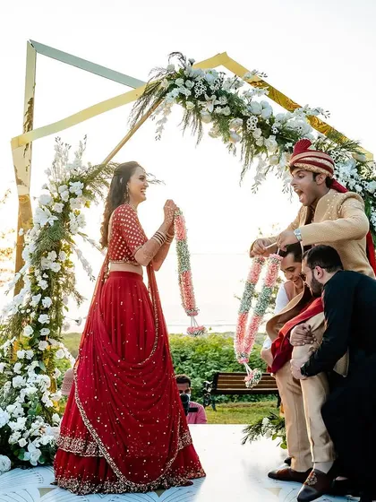 There's nothing like a golden hour Varmala ceremony, especially with the sea as the backdrop. For Aeshna and Anirudh's Goa wedding, we created a modern asymmetrical floral arch that framed their joyous moment perfectly against the setting sun.