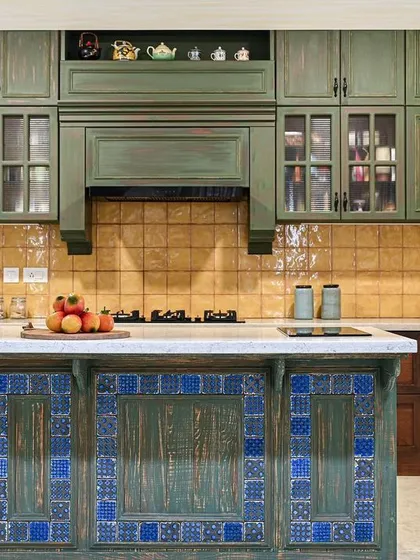 This kitchen is a celebration of color and symmetry, inspired by traditional Goan homes. The central island, with its vibrant blue tiles and aged green paint finish, is the heart of the space. We paired it with handmade yellow tiles and olive green cabinetry to create a room that feels both nostalgic and full of life, proving that functional spaces can also be joyful.