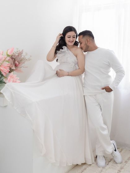 An intimate and romantic portrait by the window, with soft light enhancing the couple's connection.