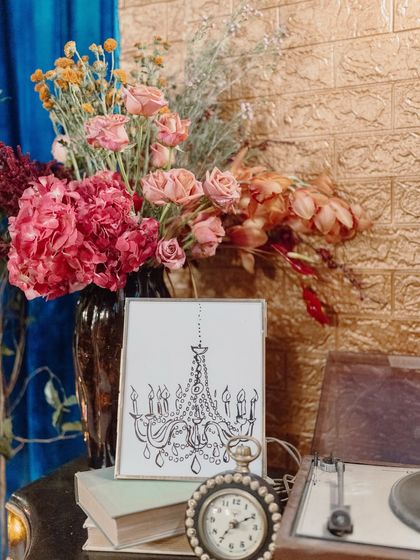 A collection of vintage-inspired props, including a gramophone, a framed chandelier sketch, and an old clock, helped build the narrative of "The Secret Waltz."