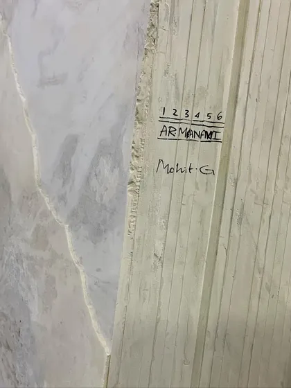 Each slab of marble is unique. Here, you can see the edge of an Armani Grey marble slab, marked and ready for a client's project. This selection process is key to achieving a cohesive and high-end interior.
