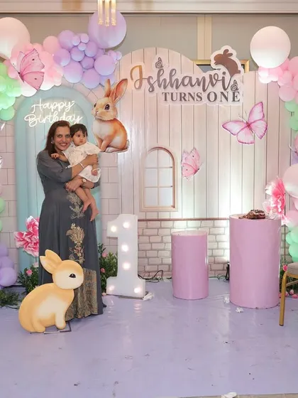 The proud mom with her one-year-old daughter in front of the bunny-themed backdrop. These are the photos they will treasure for years to come.