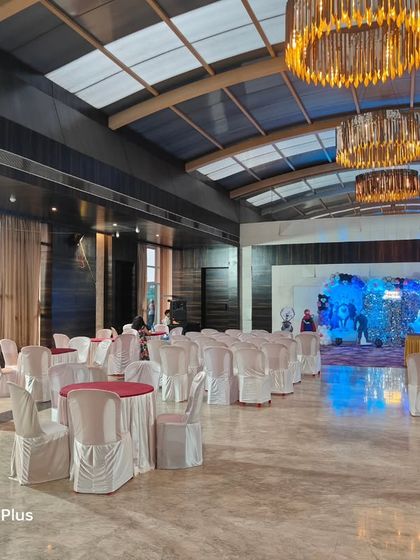 A more premium birthday party setup in a modern banquet hall. The mix of round tables and theatre-style seating provides options for guests.