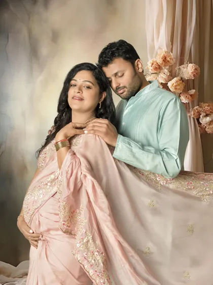 I believe in capturing the shared joy of this journey. This portrait shows a serene moment between partners, styled with a beautiful traditional saree to create a soft, painterly memory of their love and anticipation.