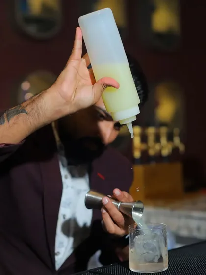 Precision in every pour. This action shot from the bar at That Place Kolkata shows the importance of accurate measurements for drink consistency, a key part of my staff training.
