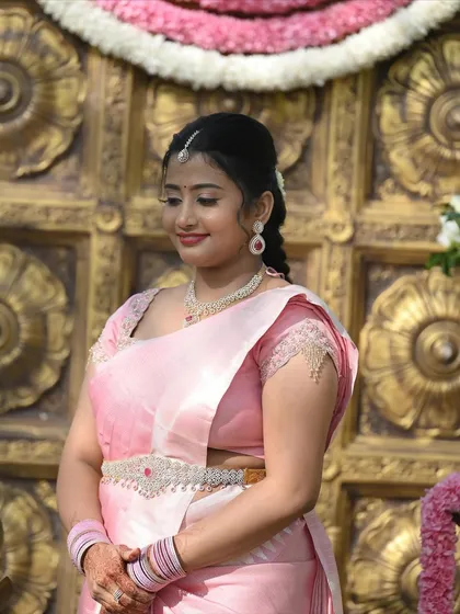 A close-up of the engagement look, showing the delicate maang tikka, simple necklace, and the soft, natural-looking makeup.
