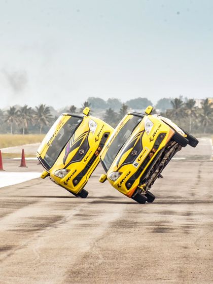 Another view of the synchronized two-wheel car stunt, a feat of incredible driving skill and precision that defies belief.