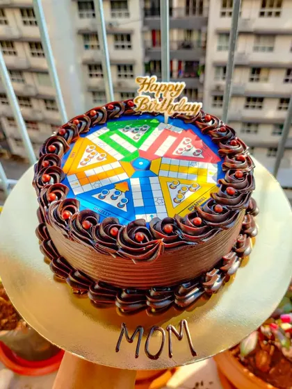 A fun prank cake for a Ludo lover. This chocolate cake is topped with an edible print of a Ludo board, perfect for someone who loves board games and a good laugh.