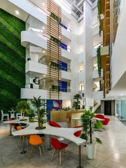 This project in Pune involved converting a hotel into a co-working space, with the atrium and its massive green wall becoming the central social hub.
