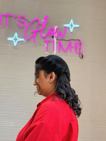 A side profile of our client enjoying her new hairstyle. The "It's Glow Time" sign in the background says it all.