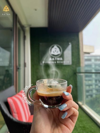 Enjoying a quiet moment with an espresso on the studio balcony. I believe wellness is about finding balance and enjoying these small rituals.