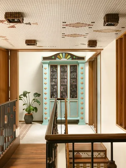 This custom bar cabinet was designed as a centerpiece for a landing. Inspired by Chettinad architecture, it features stained glass panels and a playful colour palette of mint green and ochre, making it a joyful and nostalgic statement piece.