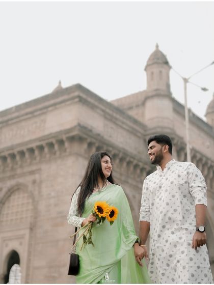 A happy, conversational moment while walking, with the iconic landmark behind them.