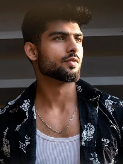 A close-up portrait of a model in a printed shirt, with strong lighting that defines his features. This is a strong, confident look for any portfolio.