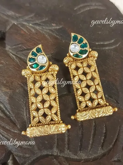 A variation of the Dakshinaya lattice-work earrings, this pair features a green enamel top, adding a subtle touch of color to the intricate gold design.