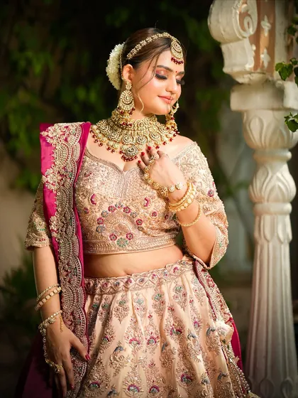 A serene and elegant pose, with the bride looking down. This shot highlights the beautiful contouring and the soft glow of her skin.