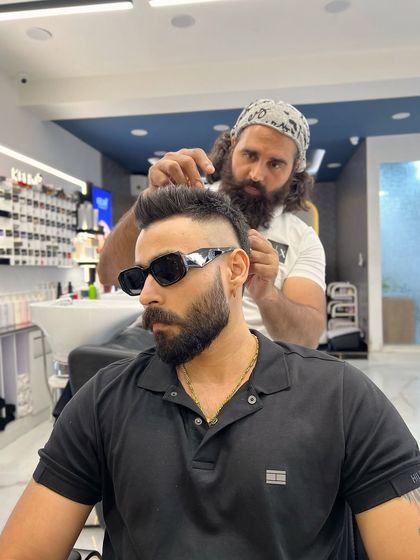 Concentration is key. Here, I'm meticulously crafting a high fade, ensuring every detail is perfect for a sharp and stylish finish.