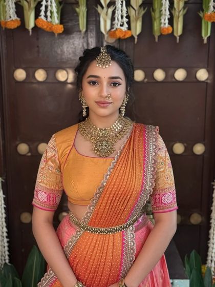 A lovely half saree look, with soft makeup and traditional jewellery that gives a timeless charm.