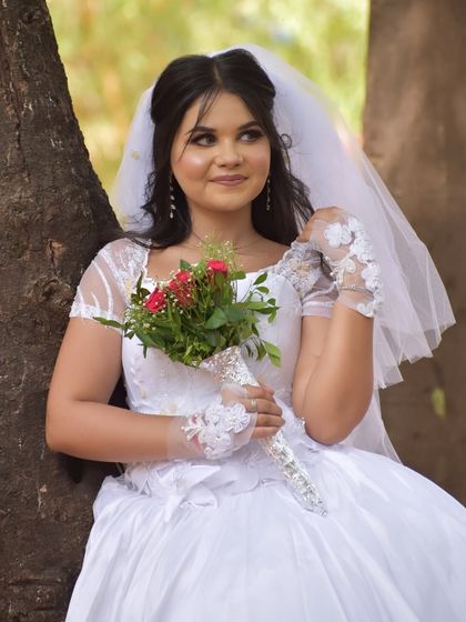 A candid shot of the Catholic bride. The hairstyle is designed to be both beautiful and comfortable, allowing her to enjoy every moment of her special day.